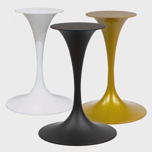 May include: Three modern pedestal tables in white, black, and gold. Each table has a round top and a flared, trumpet-shaped base. The tables are made of a smooth, glossy material and are set against a neutral background.