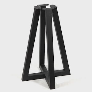 May include: A black metal table base featuring a cross-shaped floor support and four vertical legs that angle inward toward the top. Each leg terminates in a flat, rectangular mounting plate with pre-drilled holes for attachment to a tabletop surface.