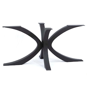 May include: A matte black metal table base featuring four curved, sweeping legs that converge at a central point. Each leg extends outward with a smooth, arched silhouette, terminating in a flat, rectangular mounting plate at the top surface.