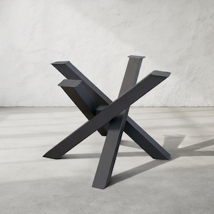 May include: A dark gray metal table base with a starburst design. The base has six angled legs that intersect in the center, creating a sturdy and modern foundation. The legs are rectangular and have flat tops.