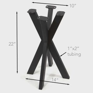 May include: A black metal table base with four angled legs made of 1 inch by 2 inch tubing. The structure stands 22 inches tall, with a 10 inch wide top mounting plate and a 14 inch wide base footprint, featuring pre-drilled holes for attachment.