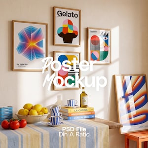 May include: A collection of framed posters with abstract and colorful graphic designs displayed on a wall above a wooden table. The table features a bowl of yellow lemons, red tomatoes, blue and white striped cups, and stacked cookbooks.