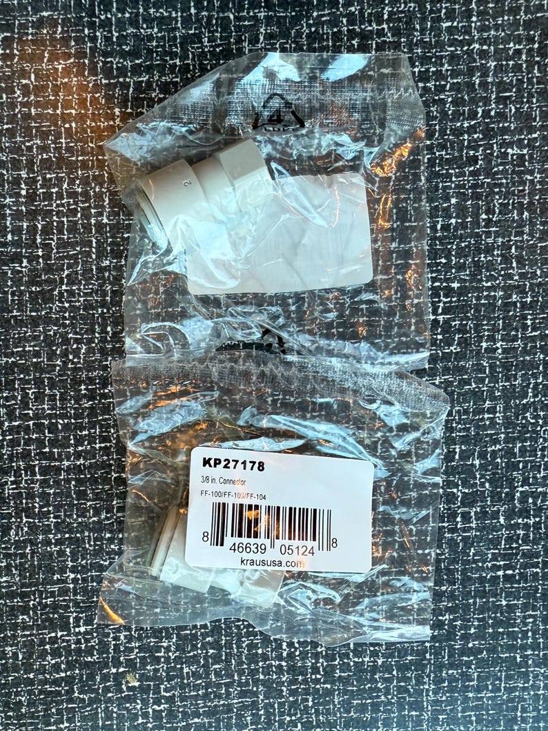 May include: A clear plastic bag contains a white connector. The bag also holds a label with the text "KP27178" and "3/8 in. Connector". The label includes a barcode and the website "kraususa.com".