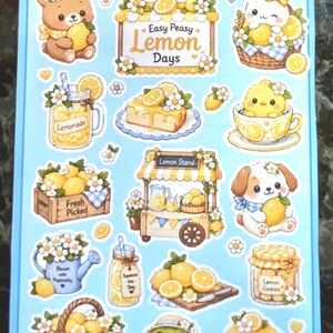 May include: A sticker sheet with a light blue background featuring various lemon-themed illustrations. Includes a bear, bunny, chick, and dog, all holding lemons. Text includes "Easy Peasy Lemon Days", "Lemonade", and "Lemon Cookies".