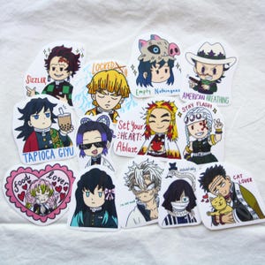 May include: A collection of colorful anime-style stickers featuring various characters with unique expressions and text. The stickers include phrases like "Sizzler," "Tapioca Giyu," and "American Breathing." The designs showcase a variety of vibrant colors and detailed illustrations.