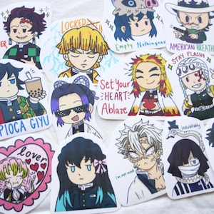 May include: A collection of colorful anime-style stickers featuring various characters. Some stickers have text like "PIOCA GIYU", "Set Your HEART Ablaze", and "STAY FLASHY". The stickers showcase a variety of designs and expressions.