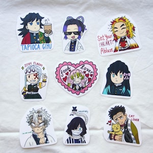 May include: A collection of nine anime-style stickers featuring colorful illustrations of characters. The stickers include text such as "Tapioca Giyu", "Set Your Heart Ablaze", "Food Lover", and "Cat Lover". The stickers are on a white background.