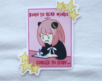 May include: A sticker featuring an anime-style character with pink hair and green eyes, writing on a notepad. The text reads "BORN TO READ MINDS" and "FORCED TO STUDY...". Yellow star accents surround the rectangular image.