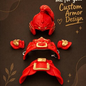 May include: Red and gold custom armor pieces, including a helmet, shoulder guards, and chest piece, are displayed on a dark brown surface. The helmet has a detailed design. The text "Message me for your Custom Armor Design" is also visible.