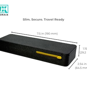 May include: Black rectangular case with a textured surface, featuring a yellow slider. The case is 7.5 inches long, 1.15 inches high, and 2.54 inches wide. The text "Slim. Secure. Travel Ready" is displayed.