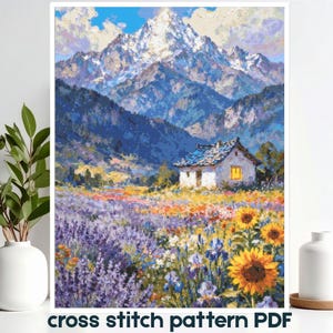 May include: A cross stitch pattern PDF featuring a landscape illustration of a white cottage with a glowing window, situated in a vibrant field of purple lavender and yellow sunflowers, set against a backdrop of towering, snow-capped mountains.