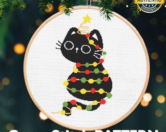 May include: A cross stitch pattern featuring a black cat decorated as a Christmas tree, adorned with colorful lights and a star on its head. The design is set within a wooden embroidery hoop. The text "Cross Stitch PATTERN" is at the bottom.