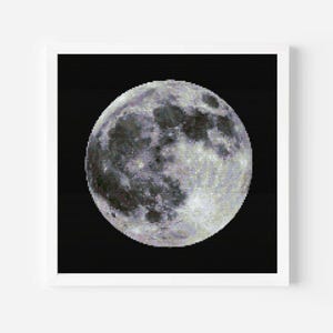 May include: A framed print featuring a detailed depiction of the moon against a black background. The moon is rendered in shades of gray and white, showcasing its craters and textured surface. The artwork is presented in a white frame.