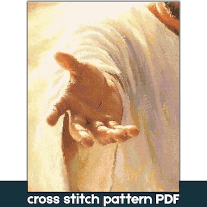 May include: A cross stitch pattern PDF featuring a digital illustration of an outstretched hand reaching forward, set against a backdrop of draped white fabric with warm golden light highlights and soft shadows throughout the composition.