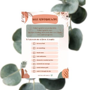 Puede incluir: Un póster motivacional con el texto "BARE MINIMUM WINS". Incluye una lista de verificación con elementos como "Me levanté de la cama", "comí algo" y "tomé agua". El diseño presenta elementos florales y geométricos en colores suaves.