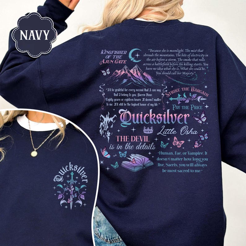May include: Navy blue sweatshirt with a graphic design featuring text, butterflies, and a mountain scene. The text includes "Quicksilver," "The Devil is in the details," and other phrases. The sweatshirt has a crew neck.