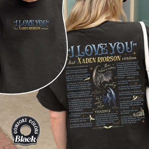 May include: Black t-shirt with the text "I LOVE YOU" but XADEN RIORSON version in blue and gold. The back of the shirt features a poem with illustrations of dragons and the word "VIOLENCE". The shirt is labeled "COMFORT COLORS Black".