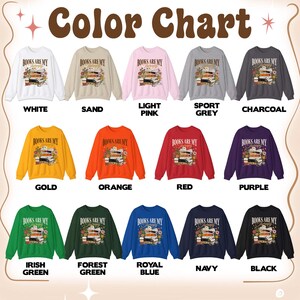 May include: A color chart displays various crewneck sweatshirts. Each sweatshirt features the text "Books are my therapy" above a stack of books and flowers. Colors include white, sand, light pink, sport grey, charcoal, gold, orange, red, purple, Irish green, forest green, royal blue, navy, and black.