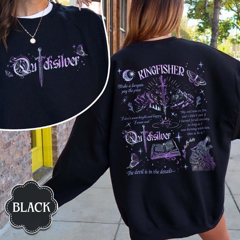 May include: Black sweatshirt with the word "Quicksilver" in a stylized font on the front and back. The back features a design with text, a wolf, butterflies, and the word "Kingfisher". The sweatshirt has a round neckline.