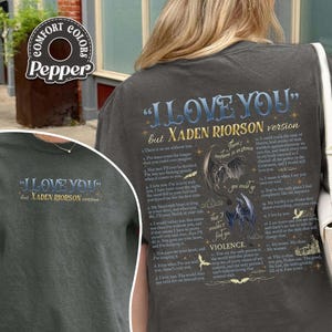 May include: Dark gray t-shirt with the text "I LOVE YOU" and "but XADEN RIORSON version" in a stylized font. The back of the shirt features a poem with illustrations of dragons and the word "VIOLENCE".