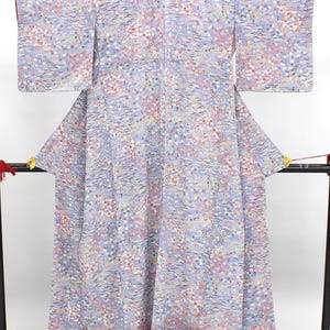 May include: A light blue kimono featuring an all-over pattern of small white, pink, and red cherry blossoms interspersed with wavy horizontal lines. The garment has wide, rectangular sleeves and a long, flowing silhouette with a structured collar.