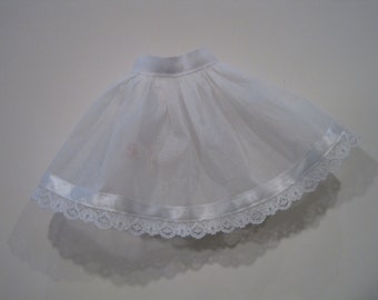May include: White tulle skirt with a satin ribbon and lace trim.