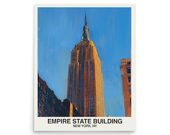May include: A framed print of the Empire State Building in New York City. The artwork depicts the iconic skyscraper in shades of orange and brown against a bright blue sky. The text "EMPIRE STATE BUILDING NEW YORK, NY" is printed at the bottom.