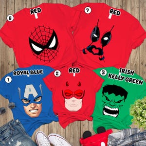 a collection of five t-shirts with different superhero and comic book character designs, including Spider-Man, Deadpool, Captain America, the Hulk, and Kelly Green.