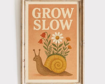 May include: A framed art print features a whimsical illustration of a snail with a yellow shell, carrying a garden of flowers. The words "GROW SLOW" are printed in large, white letters above the snail. The artwork has a vintage, rustic aesthetic.