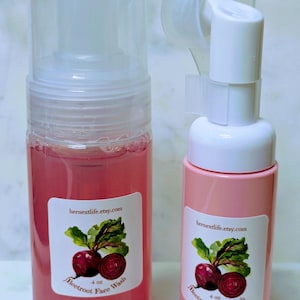 May include: Two bottles of Beetroot Face Wash. One is clear with a pink liquid, the other is pink. Both have a label with a beetroot illustration and the text "Beetroot Face Wash 4 oz" and "hernextlife.etsy.com".