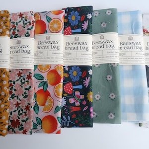 May include: A white ceramic mug with a black handle and the text "But First, Coffee" in a black, bold font. The mug is on a white surface.