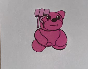 May include: A pink cartoon teddy bear illustration with a bow on its head. The bear has black eyes and a small smile. The outline is black, and the background is white.