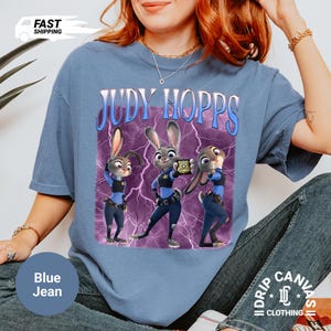 May include: A white ceramic mug with a black handle and the text "But First, Coffee" in a bold, black font. The mug is sitting on a wooden surface. The mug appears to be 12 ounces.