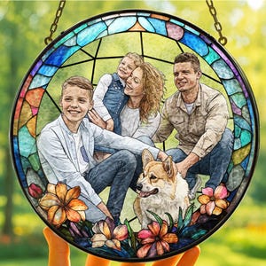 May include: A round stained glass window featuring a family portrait with a dog. The window has a black border and a chain for hanging. The image is surrounded by colorful floral accents.