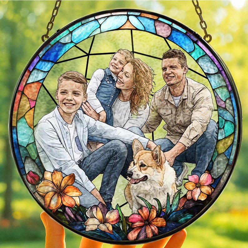 May include: A round stained glass window featuring a family portrait with a dog. The window has a black border and a chain for hanging. The image is surrounded by colorful floral accents.