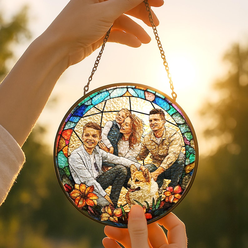 May include: A round stained glass panel featuring a family portrait with a dog, held by a chain. The panel has a colorful border and floral accents. The family is smiling, creating a warm and inviting scene.