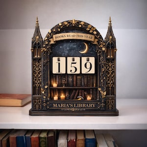 May include: A decorative bookshelf-shaped calendar with the text "BOOKS READ THIS YEAR" and the number "159". The calendar has a night sky backdrop with a crescent moon, candles, and the text "MARIA'S LIBRARY".