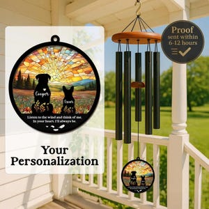 May include: A personalized wind chime featuring a round, stained-glass style design with two dog silhouettes, the names "Cooper" and "Oscar", and the text "Listen to the wind and think of me. In your heart. I'll always be." The chime has black tubes and a wooden top.