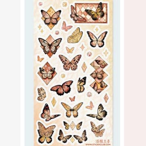 May include: A sticker sheet featuring various butterfly illustrations in shades of brown, orange, and yellow. The butterflies are in different sizes and poses, some with diamond-shaped and rectangular frames. The sheet has a soft, gradient background and includes the text "www.stickicclub.com".