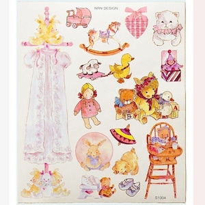 May include: A sheet of stickers featuring various baby-themed illustrations. Includes a baby carriage, rocking horse, teddy bears, a doll, a duck, a bunny, and a baby's dress. The stickers are in soft pastel colors.