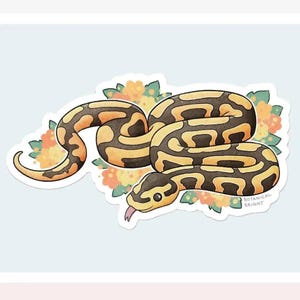 May include: A sticker featuring a cartoon illustration of a ball python snake with yellow and brown markings. The snake is surrounded by orange and yellow flowers and green leaves. The text "BOTANICAL BRIGHT" is at the bottom right.