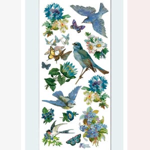 May include: A sticker sheet featuring vintage-style illustrations of blue birds, butterflies, and flowers. The designs include various shades of blue, white, and yellow, with intricate details. The text "SET VIOLETTE STICKERS" is visible at the bottom.