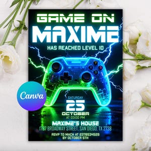 May include: A gaming-themed invitation with a neon green and blue color scheme. The text "GAME ON MAXIME" is displayed above a glowing game controller graphic. The invitation includes event details such as the date, time, and location.