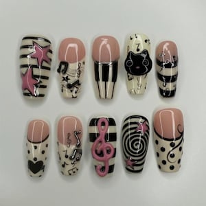 May include: A set of three ceramic mugs with a speckled, matte finish. The mugs are in shades of cream, light gray, and dark gray. Each mug has a simple, minimalist design and a rounded handle. The mugs are likely for coffee or tea.