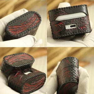 May include: Black leather AirPod case with red floral design and visible stitching. The case is rectangular with rounded edges and a charging port opening. The case is shown from multiple angles.