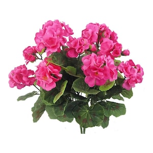 May include: A cluster of artificial geraniums in a vivid fuchsia hue. The flowers are densely packed, showcasing multiple blooms. The leaves are a rich green, speckled with darker markings. The stems are visible at the base, creating a natural look.