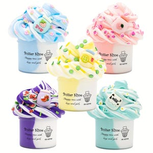 May include: Five colorful butter slime containers. Each container has a different color scheme, including blue, pink, yellow, purple, and teal. The slimes are decorated with various charms and sprinkles. Each container has the text "Butter Slime" and "Happy time with boys and girls".