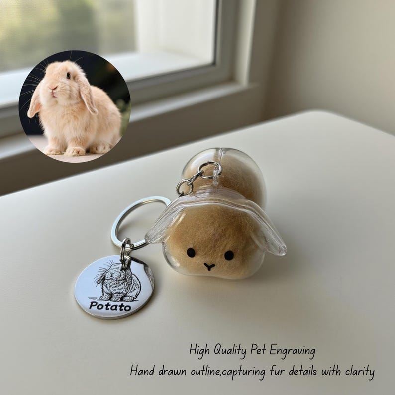 May include: A keychain featuring a small, fluffy bunny encased in clear plastic. The keychain includes a silver tag with a bunny illustration and the name "Potato." The image also includes a photo of a bunny and text that reads "High Quality Pet Engraving."