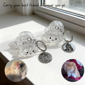 May include: Clear plastic bunny-shaped keychains with silver keyrings and engraved pet portrait charms. The keychains have a cute face design. The text "Carry your best friend wherever you go" is at the top.