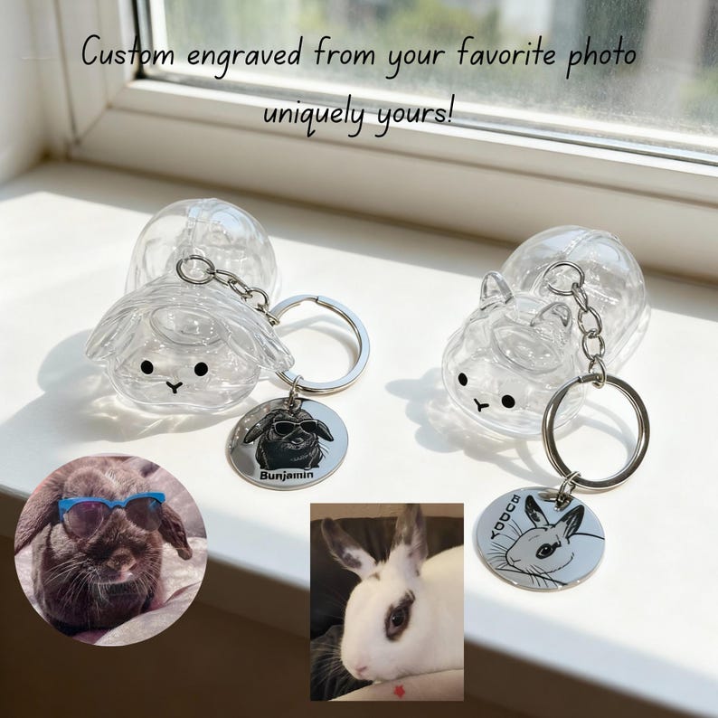 May include: Clear, animal-shaped keychains with engraved pet portraits. Each keychain features a small, round tag with a custom engraved image of a pet. The text "Custom engraved from your favorite photo uniquely yours!" is visible.